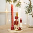 Pähkinänsärkijällä, joulukuusilla ja lasihelmillä koristeltu kynttilänpidike